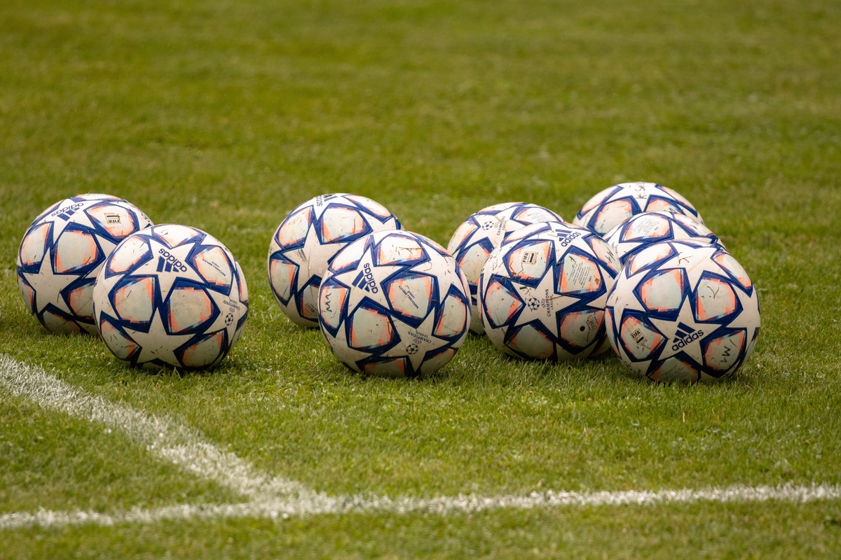 Mehrere Fußbälle auf Rasen